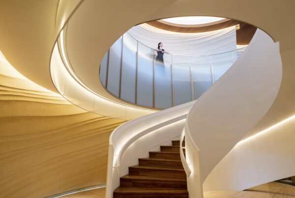 A solo traveler stands above the sweeping spiral staircase at InterContinental Yokohama Pier 8 in Japan.